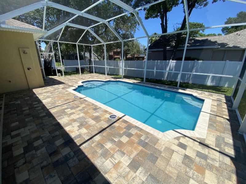 Clean swimming pool and stone surface after pressure washing