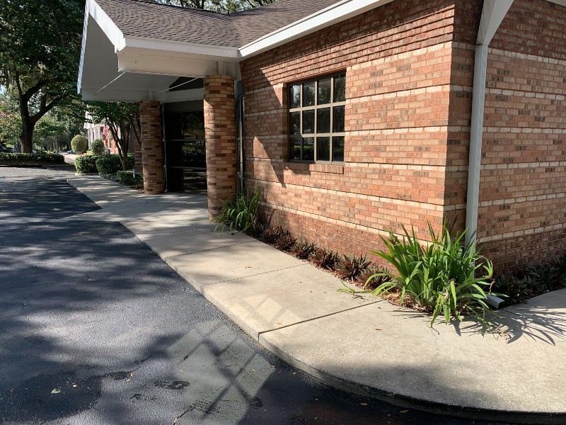 Clean brick house exterior and pavement from residential pressure washing service