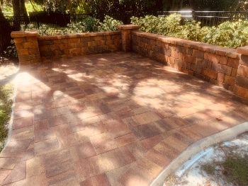 Earthy, traditional-looking patio is clean after pressure washing and paver sealing
