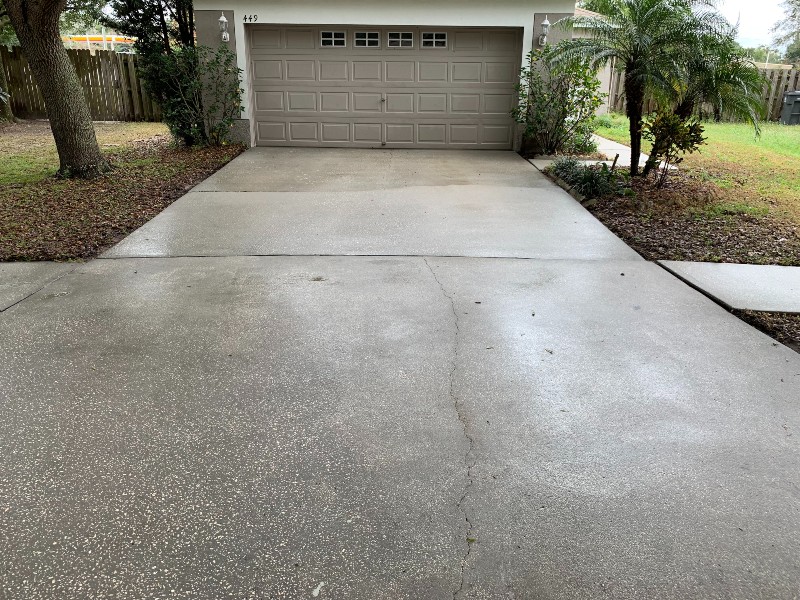 Freshly cleaned and maintained garage driveway using pressure washer