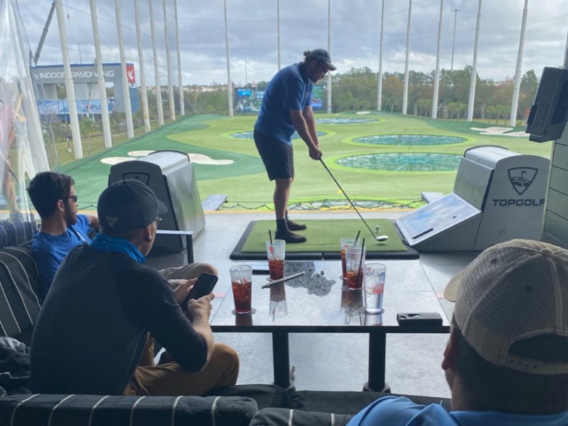 A man is playing golf together with his friends